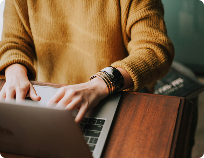 Individual reviewing finances or investments on laptop at home