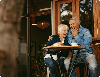 Retired couple enjoying coffee together, symbolizing financial freedom and peace of mind
